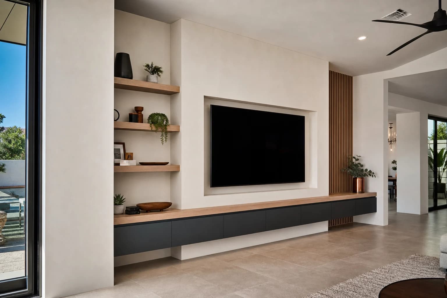 Mesa Arizona living room with custom media wall, recessed TV niche, low floating cabinets, and asymmetric wood shelves